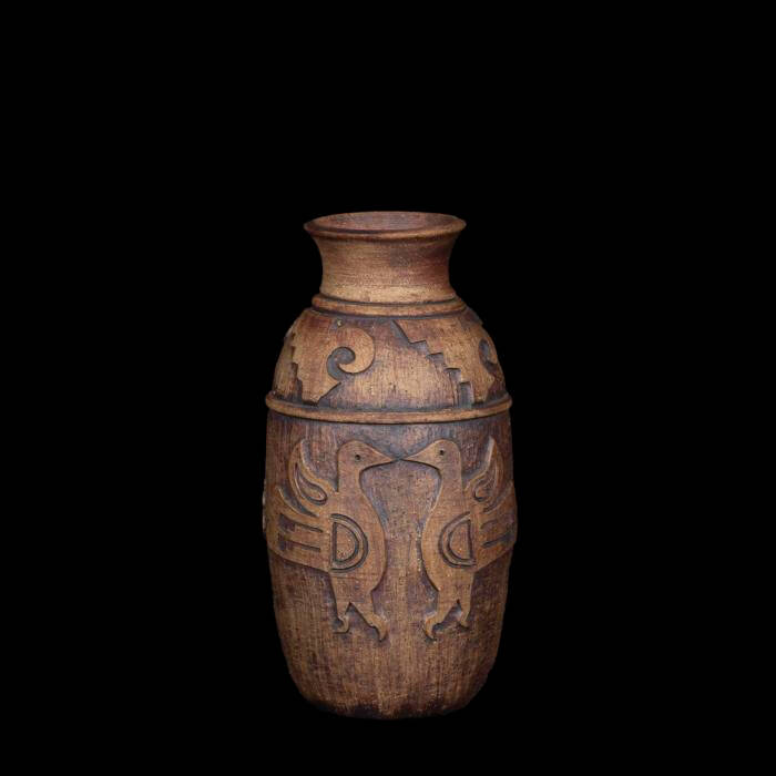 A cylindrical ceramic brown vase with Hopi Bird forms.